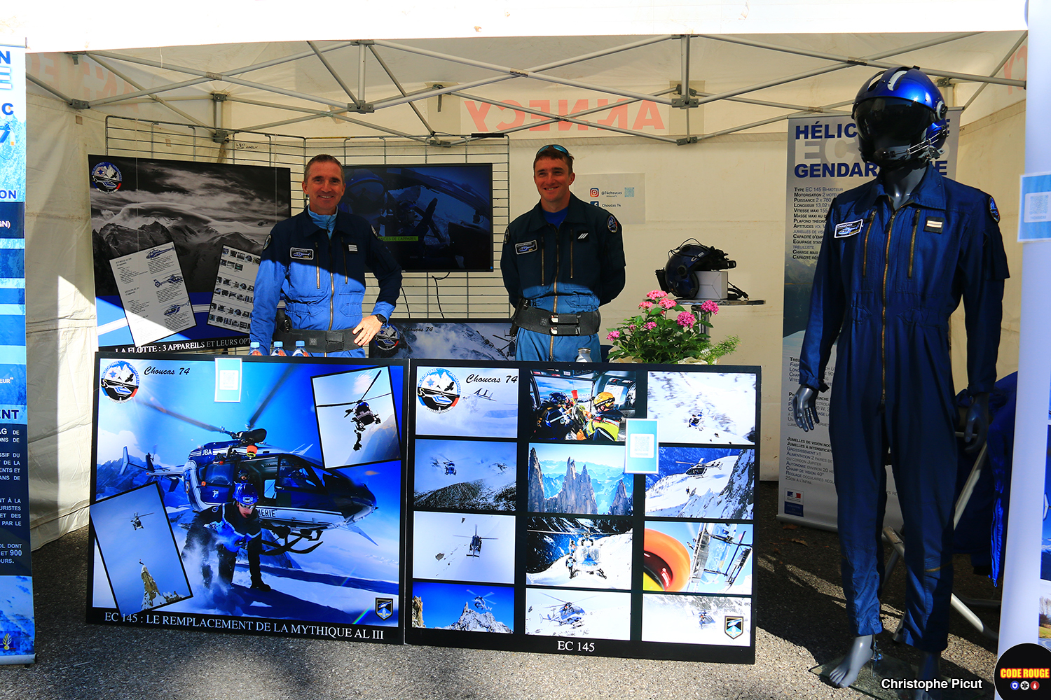 Deux gendarmes en tenue de vol derrière le stand consacré à l'hélicoptère de la gendarmerie
